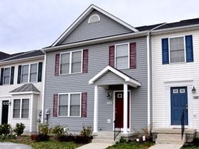 Winchester townhouse for rent - a gray house with blue doors and a red door