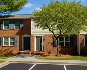 Winchester townhouse for rent - A tree in front of a house with a green door.