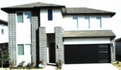 Richmond house for rent - A white house with a black garage door.