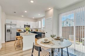 Denton apartment for rent - an open kitchen and dining area with a table and chairs