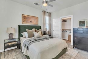 Denton apartment for rent - a bedroom with a bed and a ceiling fan