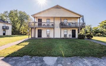 Bowling Green apartment for rent - the front of a white house with a yard and a balcony