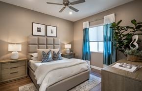Surprise apartment for rent - a bedroom with a bed and a ceiling fan
