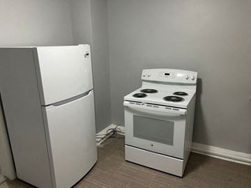 Wahpeton apartment for rent - A white refrigerator and a white stove in a kitchen.