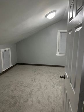 Wahpeton apartment for rent - A room with a carpeted floor and a white door.