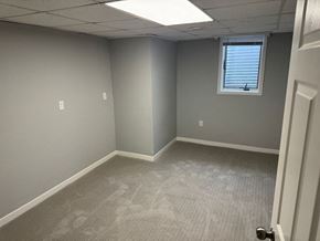 Wahpeton apartment for rent - A room with a carpeted floor and a door on the right side.