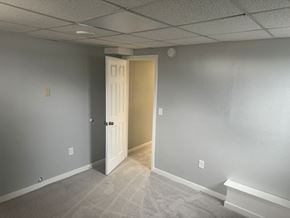 Wahpeton apartment for rent - A room with a carpeted floor and a white door.