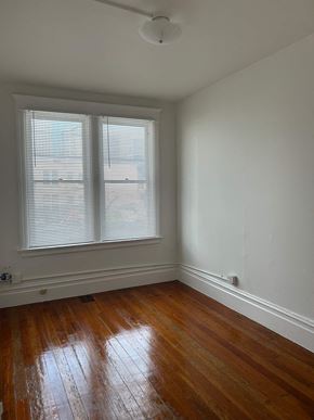 San Francisco apartment for rent - A room with wooden floors and a window with blinds.