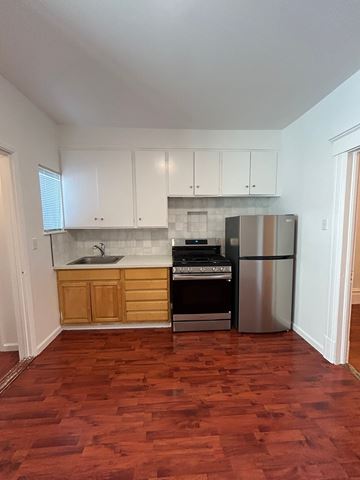 San Francisco apartment for rent - A kitchen with wooden cabinets and a stainless steel refrigerator.