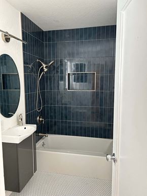 San Francisco apartment for rent - A bathroom with a white sink and a black tiled shower.