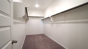 Royse City house for rent - a room with white walls and a gray carpet and a closet with a white door