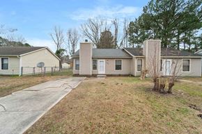 Jacksonville house for rent - the front of a house with a yard and a sidewalk