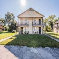 Bowling Green apartment for rent - a yellow house with a lawn in front of it