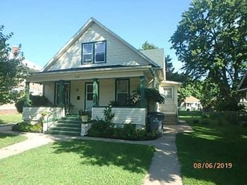 Grand Island apartment for rent - a house with a front porch and a sidewalk