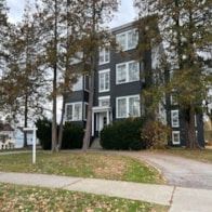 Poughkeepsie apartment for rent - A grey building with a white door and windows.