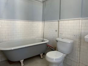 Poughkeepsie apartment for rent - A white toilet sits next to a bathtub in a bathroom.