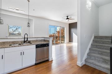 Charlotte apartment for rent - A kitchen with white cabinets and a granite countertop.