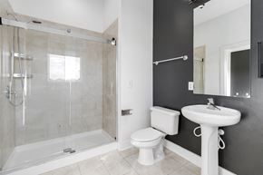 Charlotte apartment for rent - A white toilet sits next to a white sink in a bathroom.