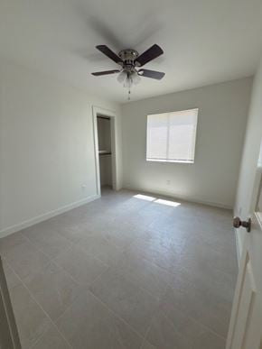 Austin house for rent - A room with a ceiling fan and a window.