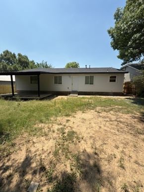 Austin house for rent - A house with a white exterior and a brown roof is surrounded by a grassy area.