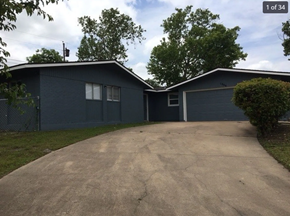 Killeen house for rent - A two-car garage with a driveway leading to it.