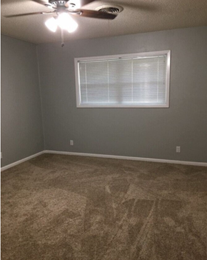 Temple house for rent - a carpeted room with a window and a ceiling fan