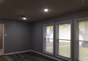 Temple house for rent - a living room with large windows and a wooden floor