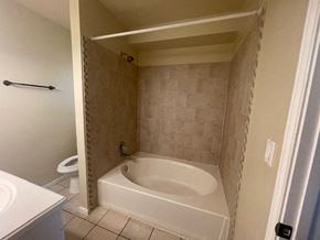 Killeen house for rent - a bathroom with a tub and a toilet and a sink