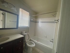 Killeen house for rent - a bathroom with a toilet and a tub and a sink