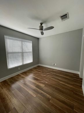Austin apartment for rent - a living room with wood floors and a ceiling fan