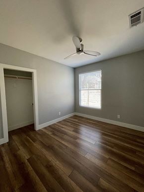 Austin apartment for rent - a living room with wood floors and a ceiling fan