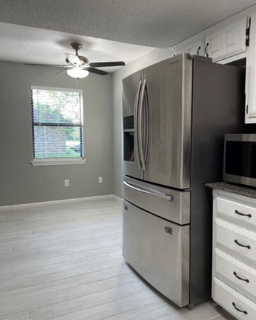 Killeen house for rent - a kitchen with a stainless steel refrigerator and a ceiling fan