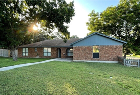 Killeen house for rent - the front of a brick house with a grassy yard and trees