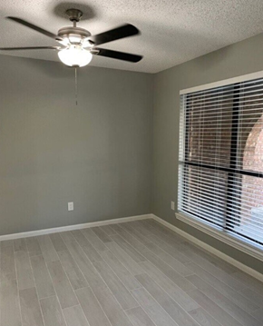 Killeen house for rent - a living room with a large window and a ceiling fan