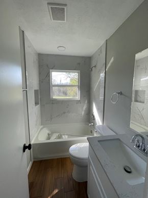 Killeen house for rent - a white bathroom with a tub and a toilet and a sink