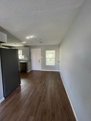 Killeen house for rent - an empty living room and kitchen with a refrigerator