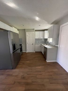 Killeen house for rent - a kitchen with stainless steel appliances and a wooden floor