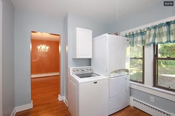 Comstock Park house for rent - a white kitchen with a stove and a refrigerator