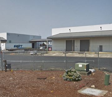 Tacoma apartment for rent - a building with a chain link fence in front of it