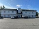 Tacoma apartment for rent - a large white building with cars in front of it