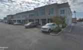Tacoma apartment for rent - a building with cars parked in a parking lot