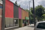 Tacoma apartment for rent - a colorful building on a city street with a car