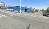 Tacoma apartment for rent - a parking lot in front of a blue building
