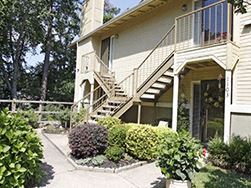 Little Rock apartment for rent - a house with stairs and a yard with bushes