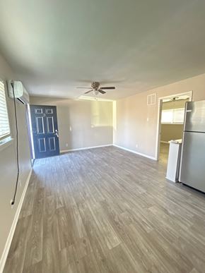 Killeen apartment for rent - A room with a ceiling fan and a door.