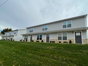 Lima apartment for rent - A row of houses with grey siding and dark grey doors.