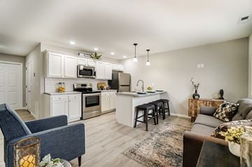 Lima apartment for rent - A modern kitchen with a blue chair and a brown couch.