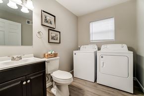 Lima apartment for rent - A bathroom with a white toilet, sink, and washer and dryer.