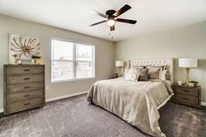 Lima apartment for rent - A bedroom with a large bed, a dresser, and a ceiling fan.