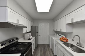 Memphis apartment for rent - a kitchen with white cabinets and appliances and a sink